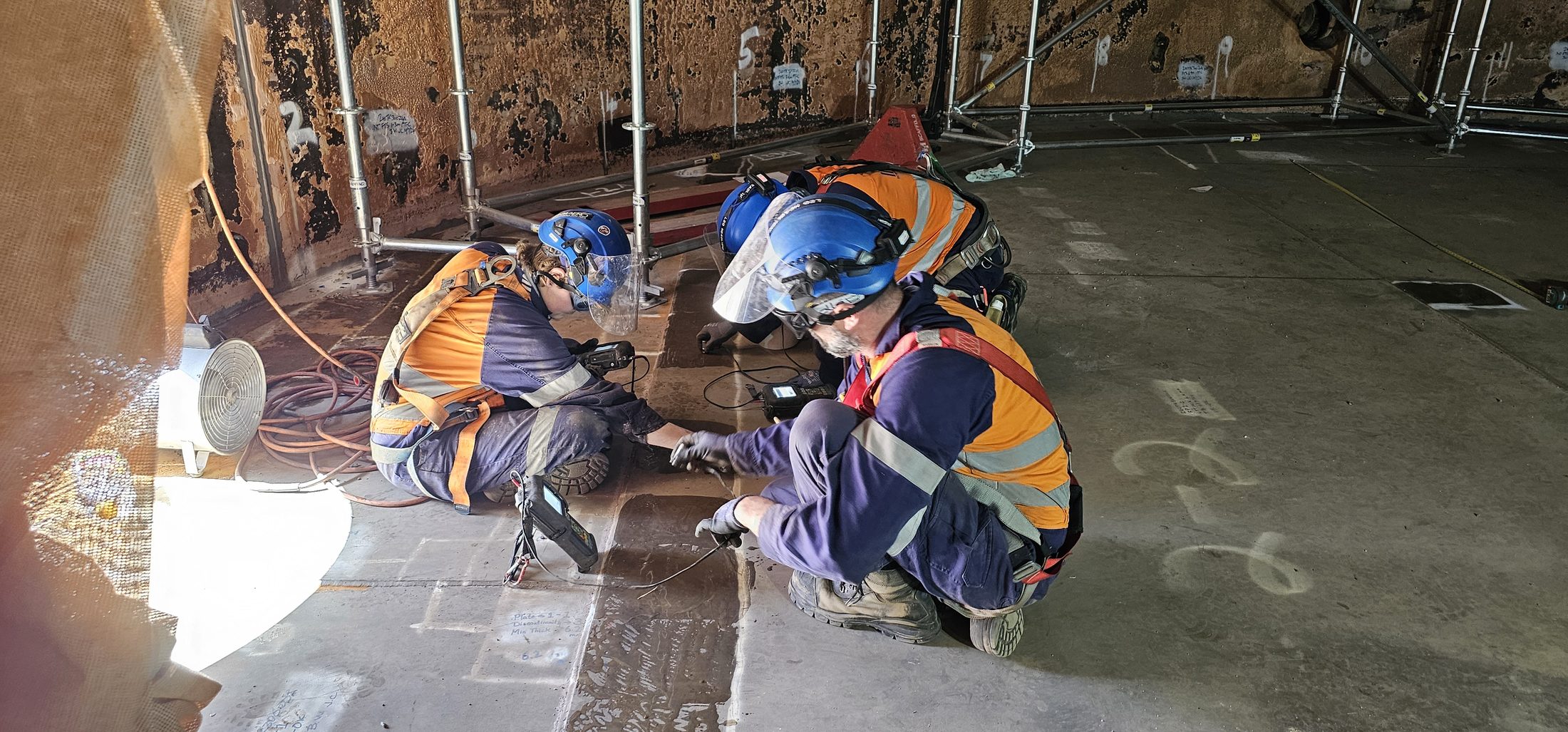 Inspection technicians carrying out NDT inside a storage tank