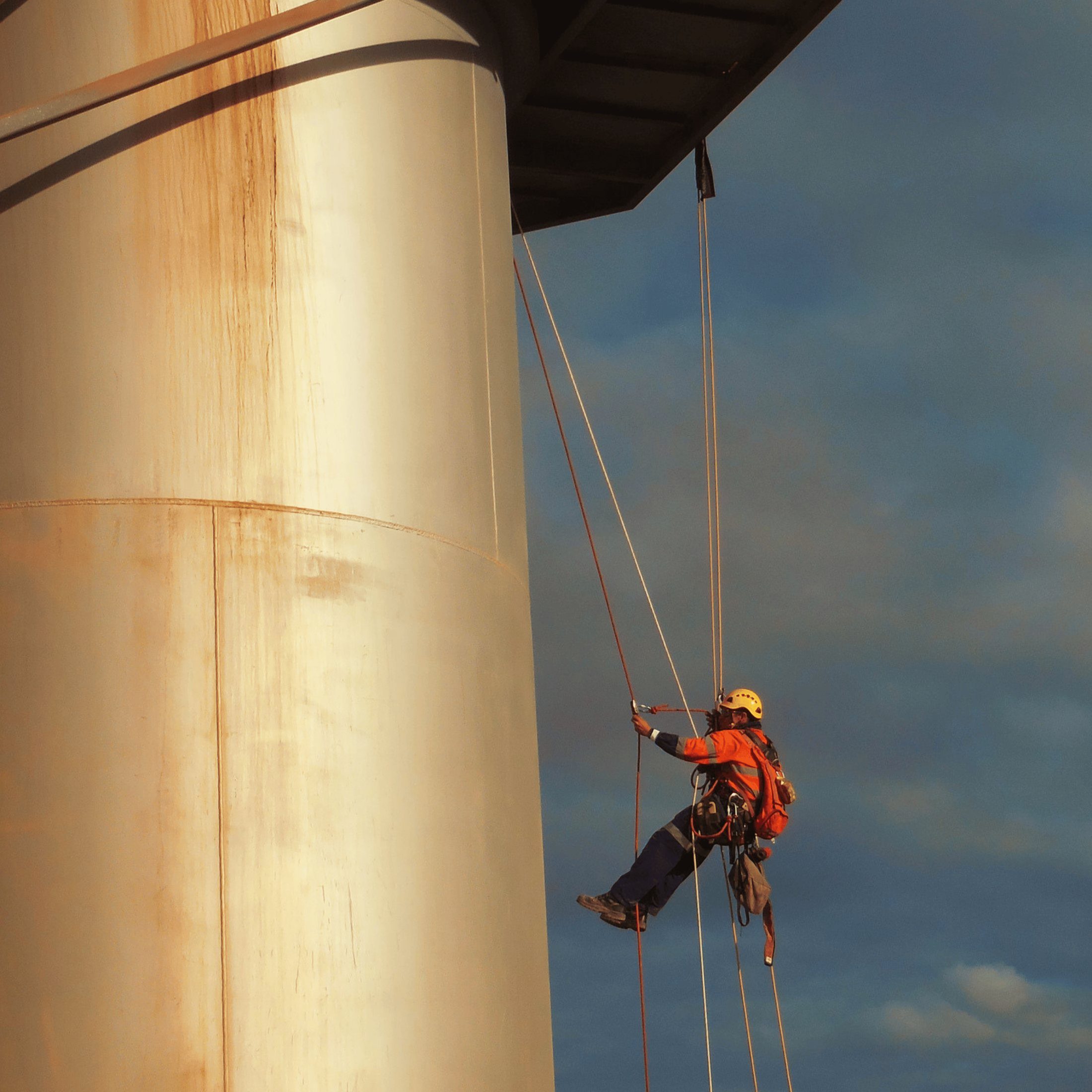 Rope access technician inspecting an industrial tank shell